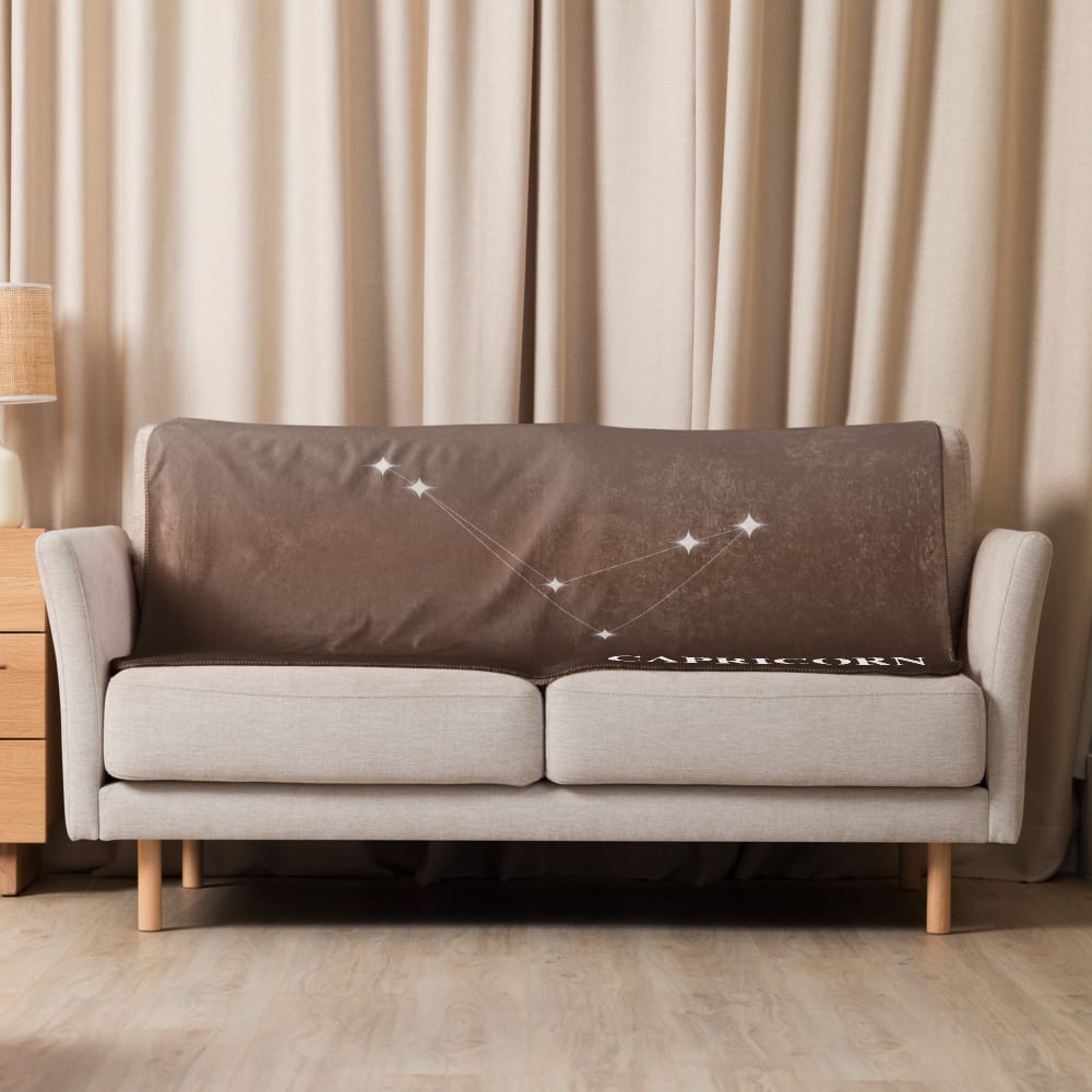 Capricorn Zodiac Blanket in Sunlit Umber in a lifestyle setting